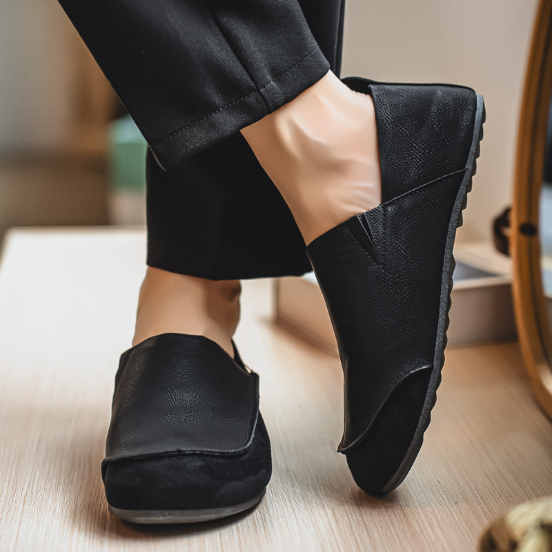 Black slip-on casual shoes shown on foot