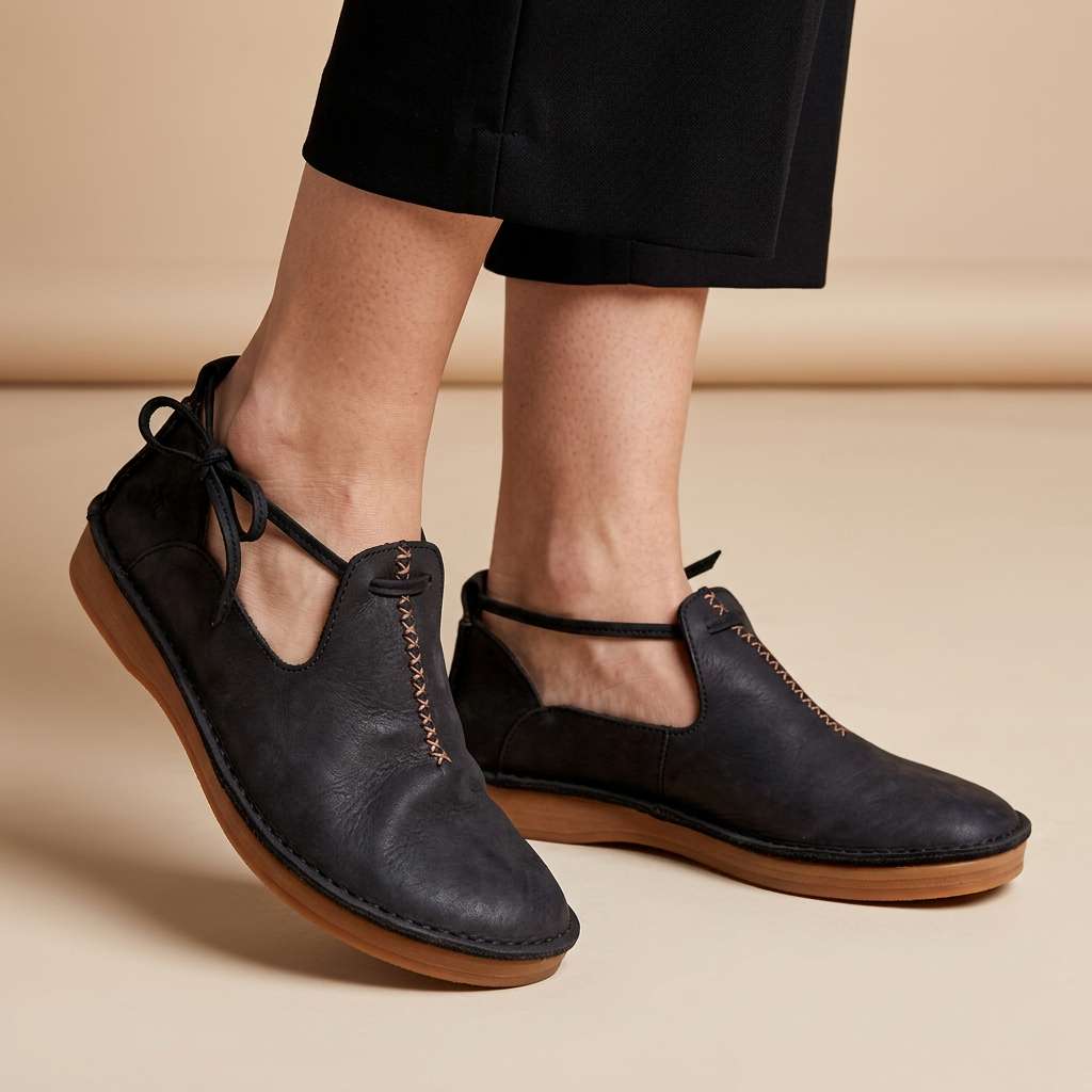 Delaina Women's Vintage Cutout Lace-Up Flats — Black lace-up flats on foot