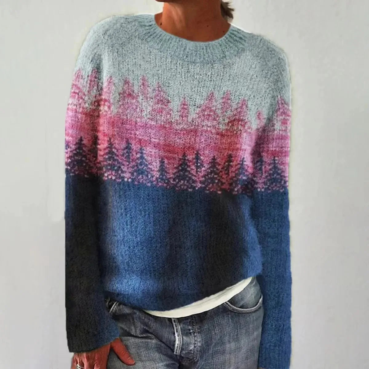 Women's blue and pink knit sweater with a pine forest pattern