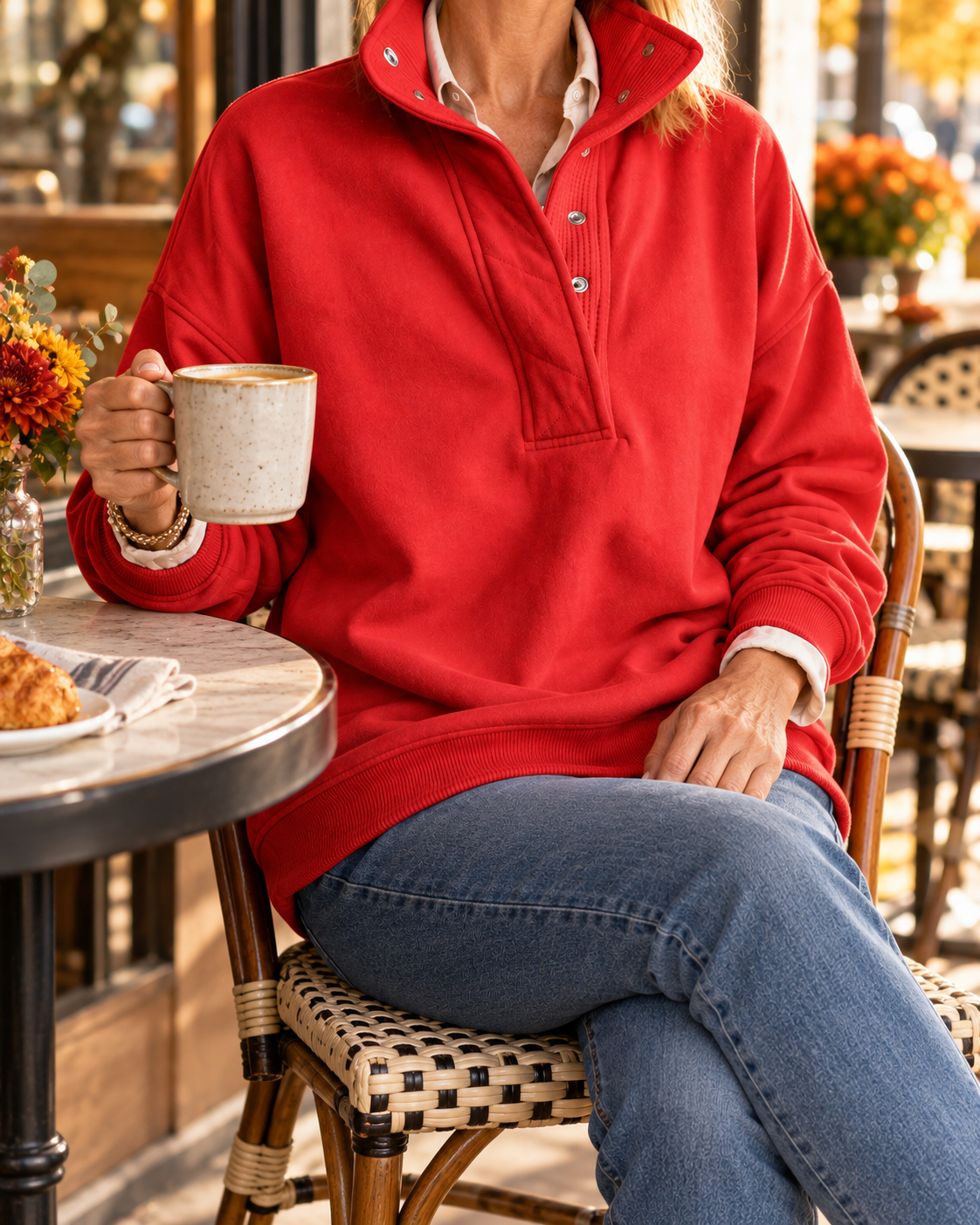 Scarlet red pullover styled at a cozy caf&eacute;; model face not shown