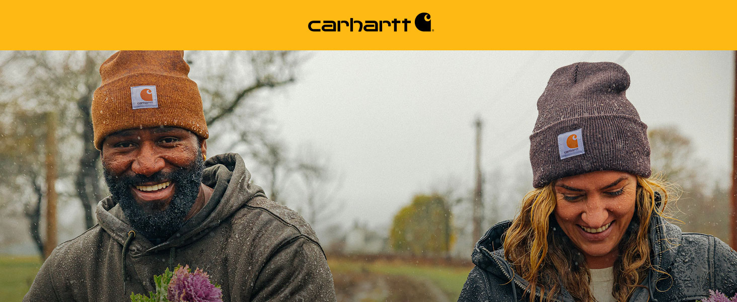 Man and women wearing Carhartt's Knit Cuffed Beanie at a flower farm