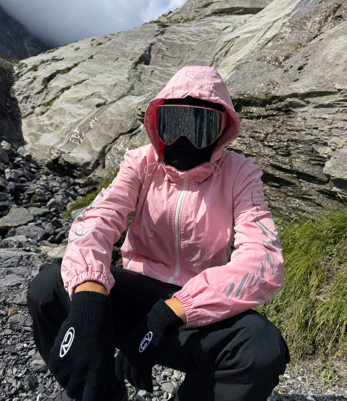 Person wearing pink 3-in-1 windbreaker jacket outdoors