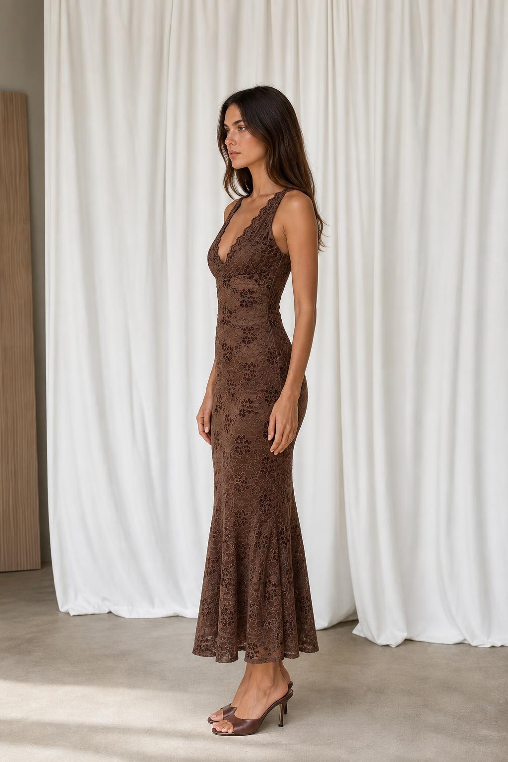 Side profile view of model in brown lace midi dress