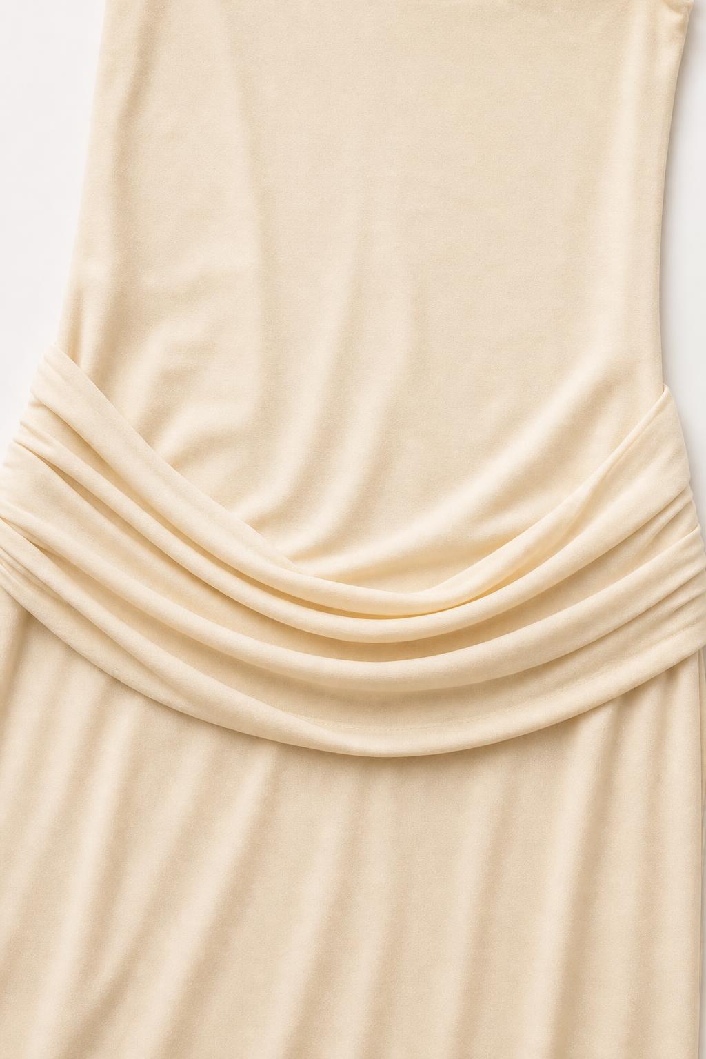 Close-up detail of the waist draping on the Champagne dress