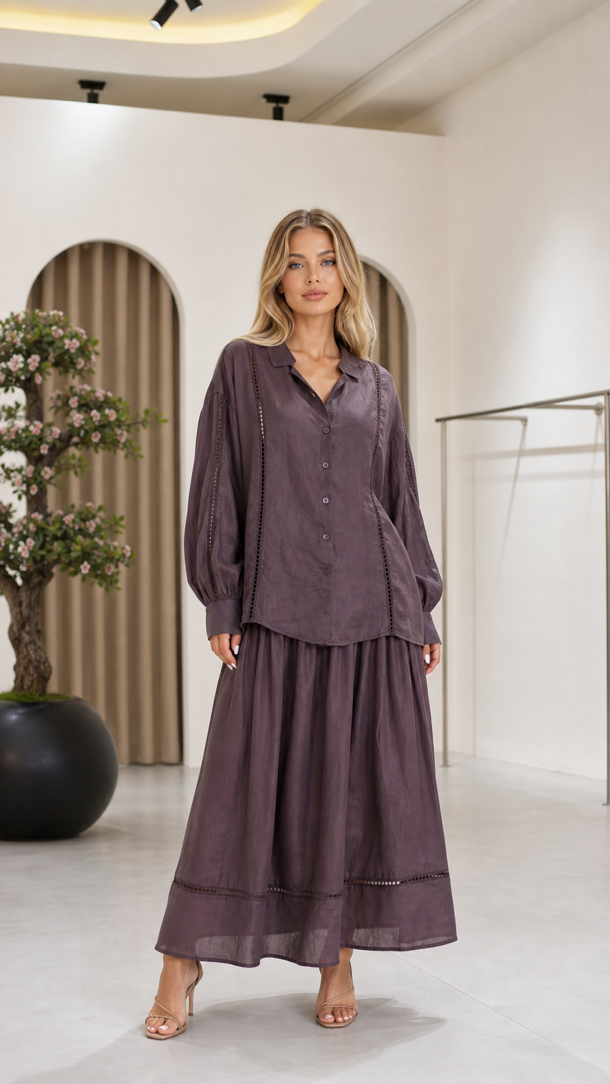 Front view of a mauve women's blouse and flowing maxi skirt two-piece set