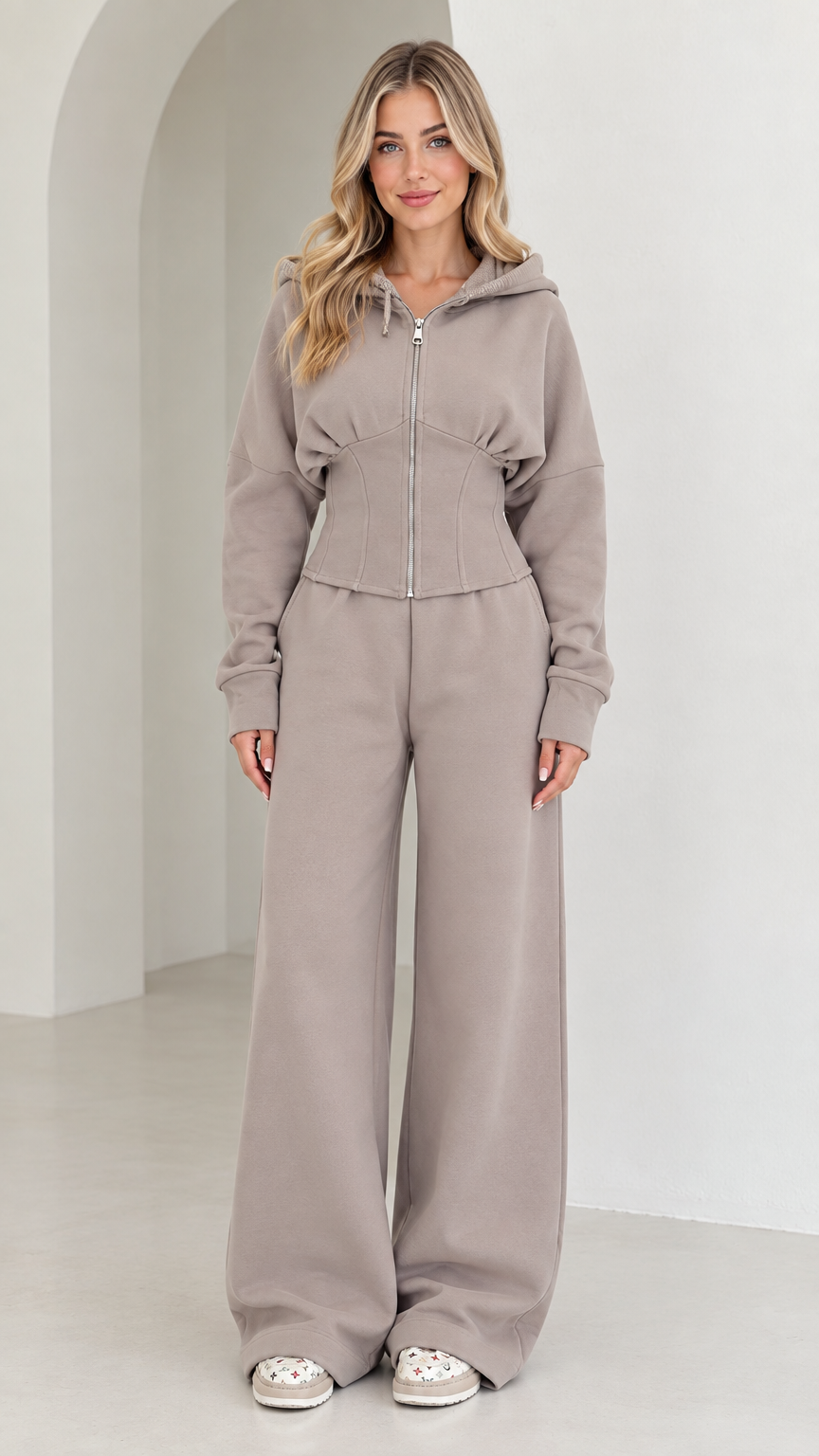 Front full-length view of woman wearing taupe corset zip-up hoodie and wide-leg sweatpants