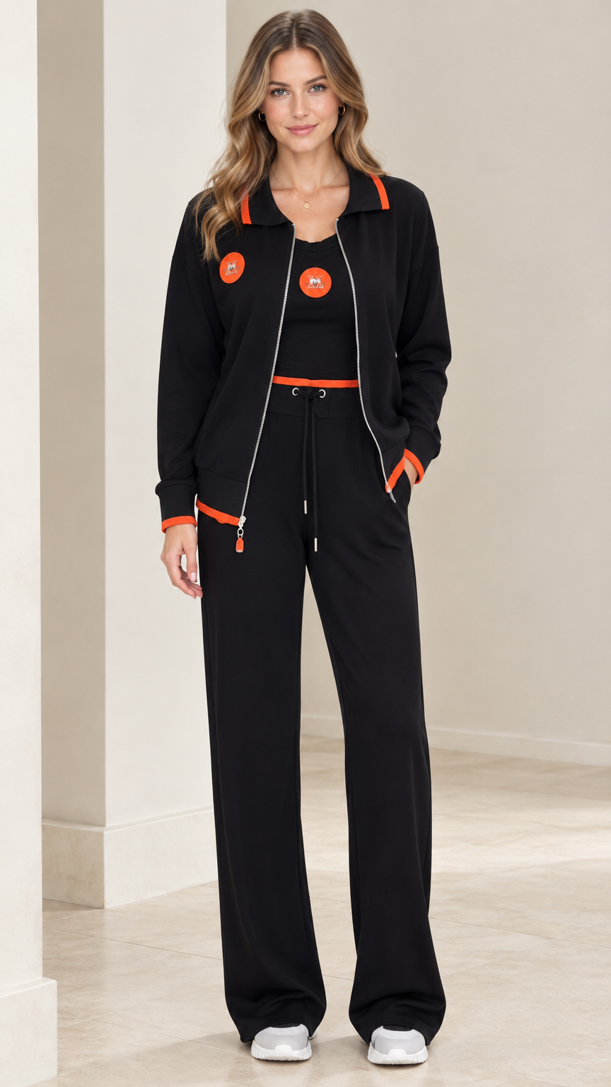 Front view of model wearing black 3-piece tracksuit set with orange trim