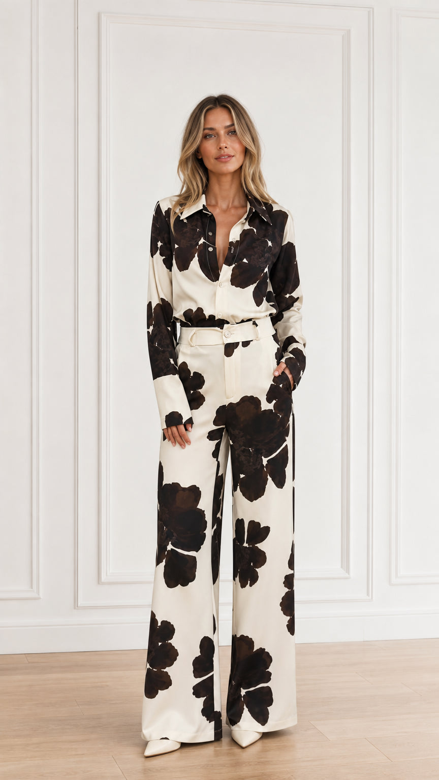 Woman wearing floral print button-down shirt and wide-leg trousers set in cream front view