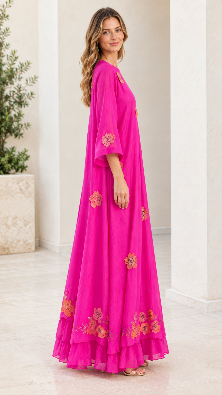 Side profile of fuchsia flowing maxi dress with 3/4 flared sleeves