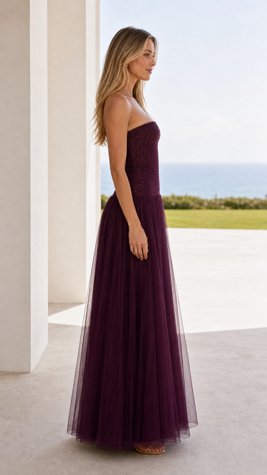 Side view of burgundy strapless ruched tulle maxi dress