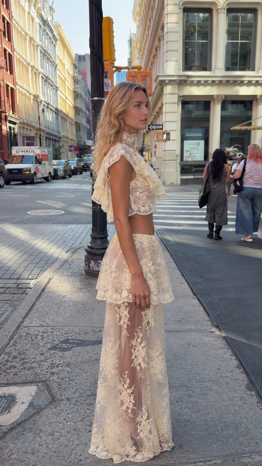 Side angle view of model wearing cream lace two-piece maxi skirt set