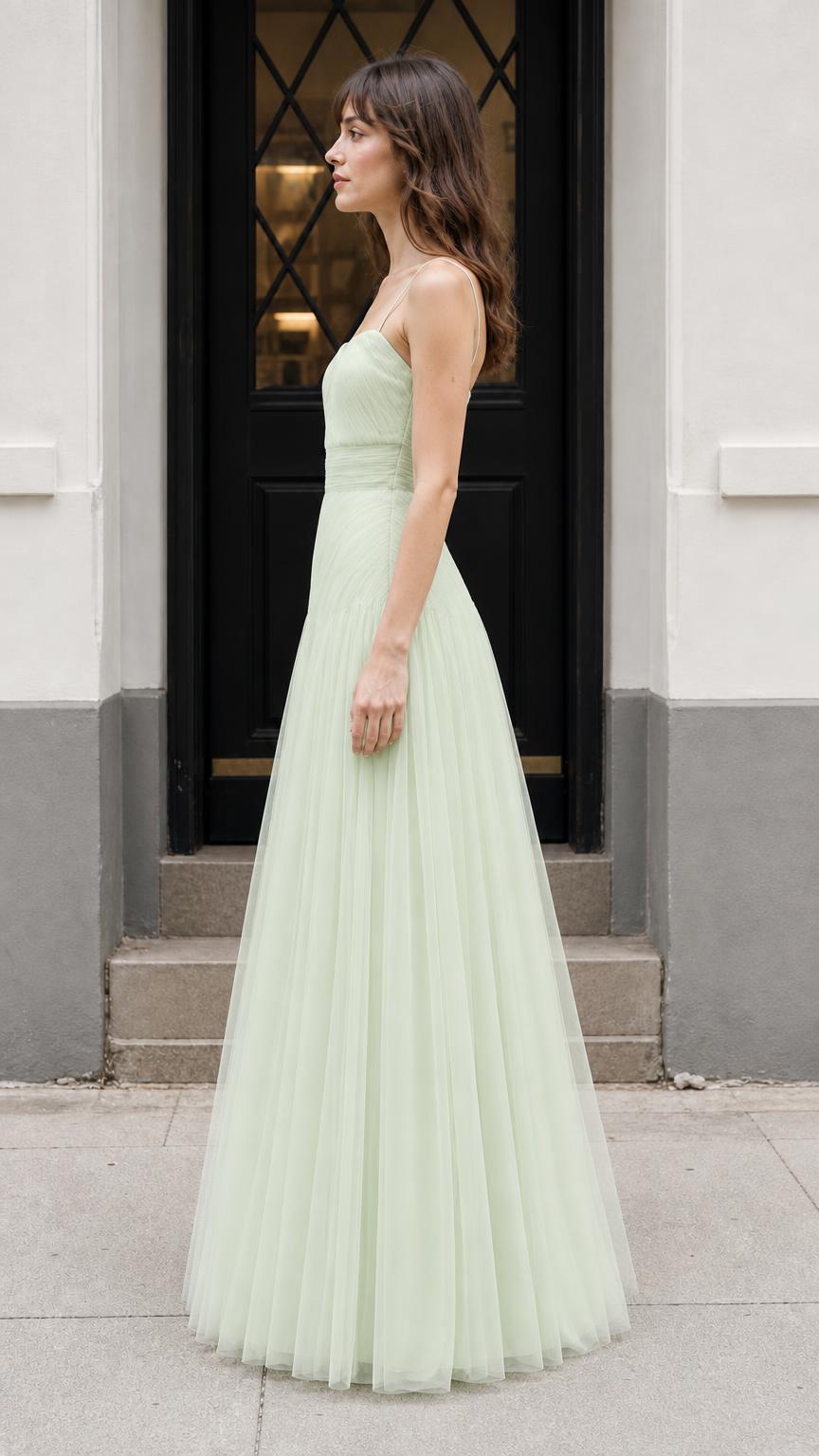 Side profile of model in sage green evening gown