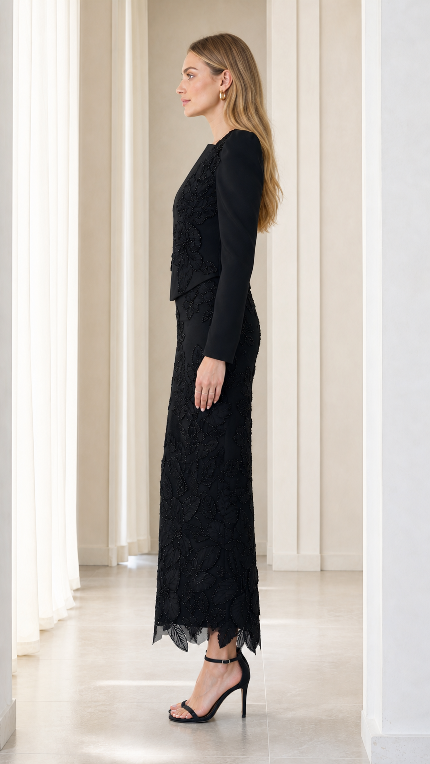 Side profile view of black long sleeve embroidered formal evening gown