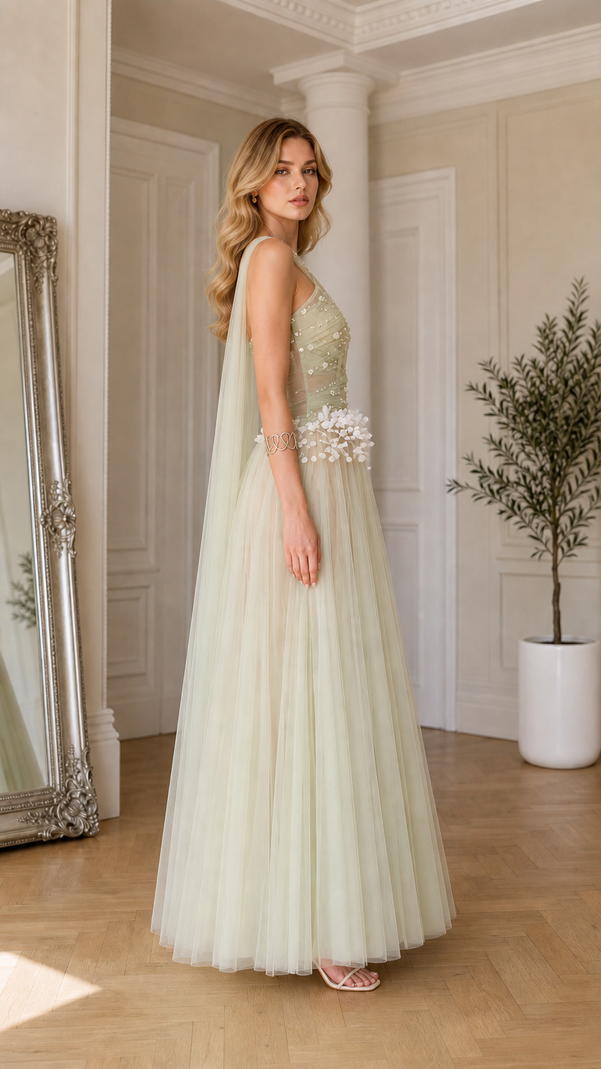 Side profile of sage green halter formal dress showing flowing shoulder drape and A-line silhouette
