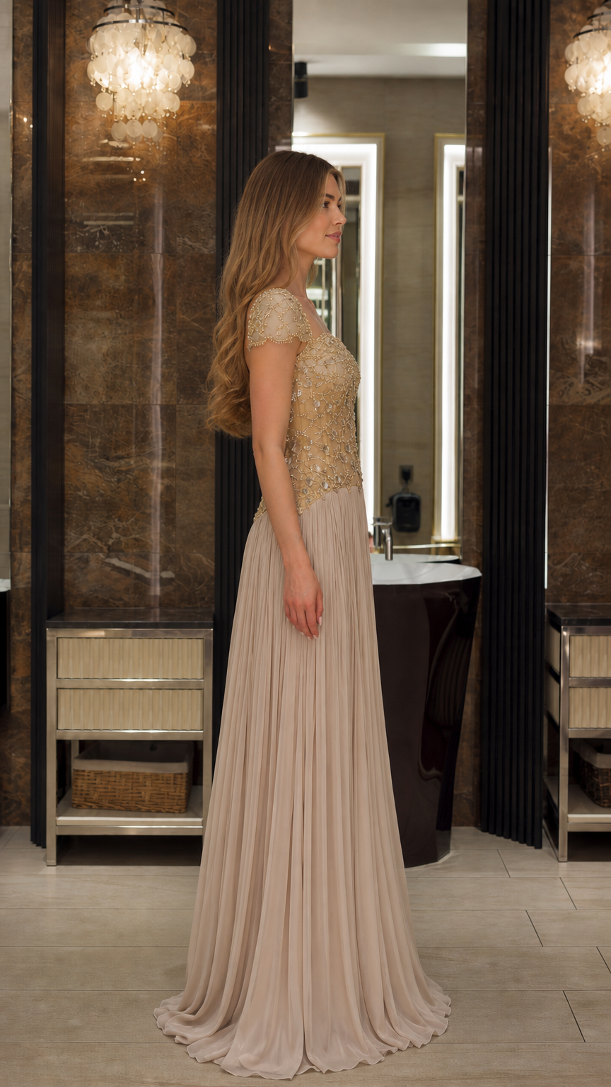 Side profile view of the Champagne beaded floor length formal evening gown