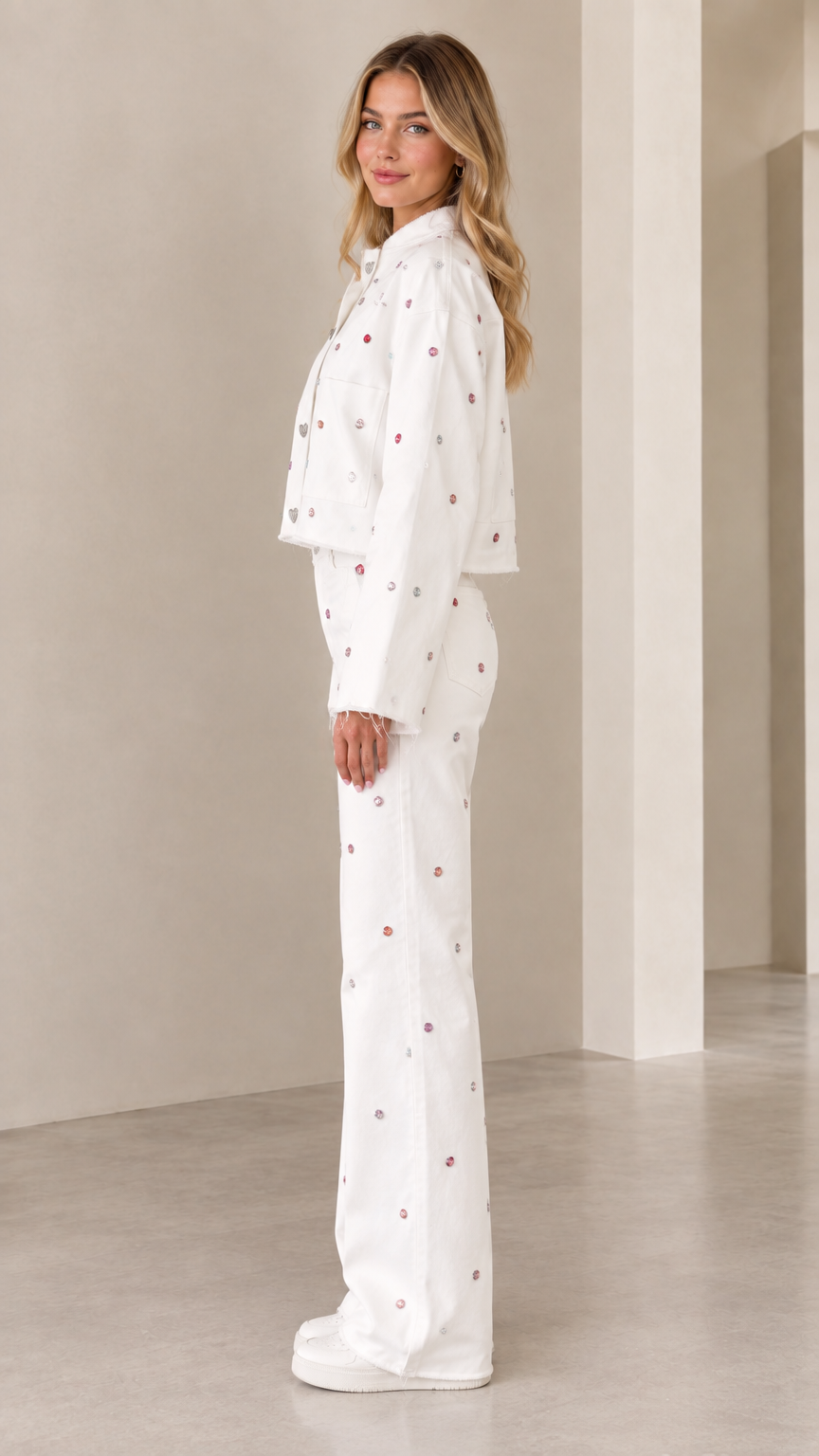 Side profile view of woman modeling white rhinestone two-piece co-ord pant set