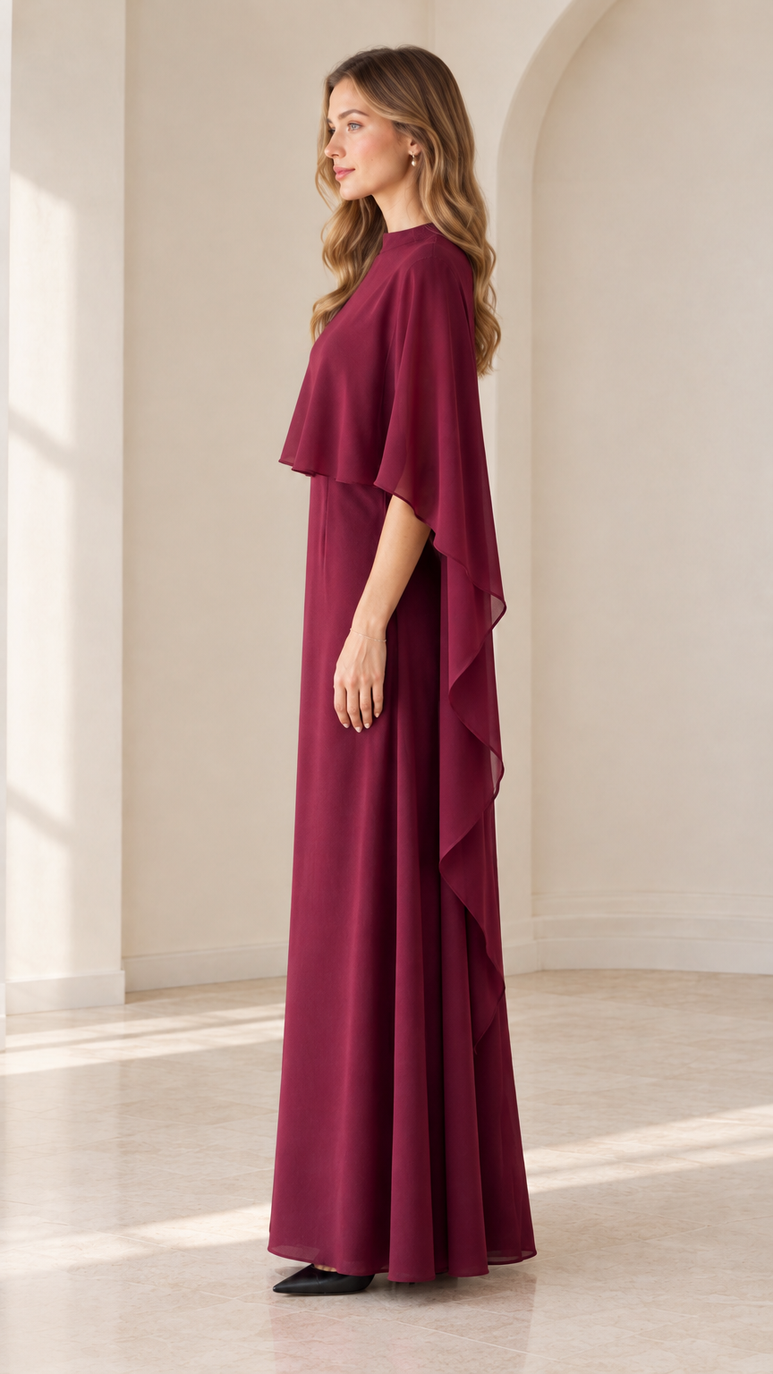 Side view of burgundy floor-length cape evening gown
