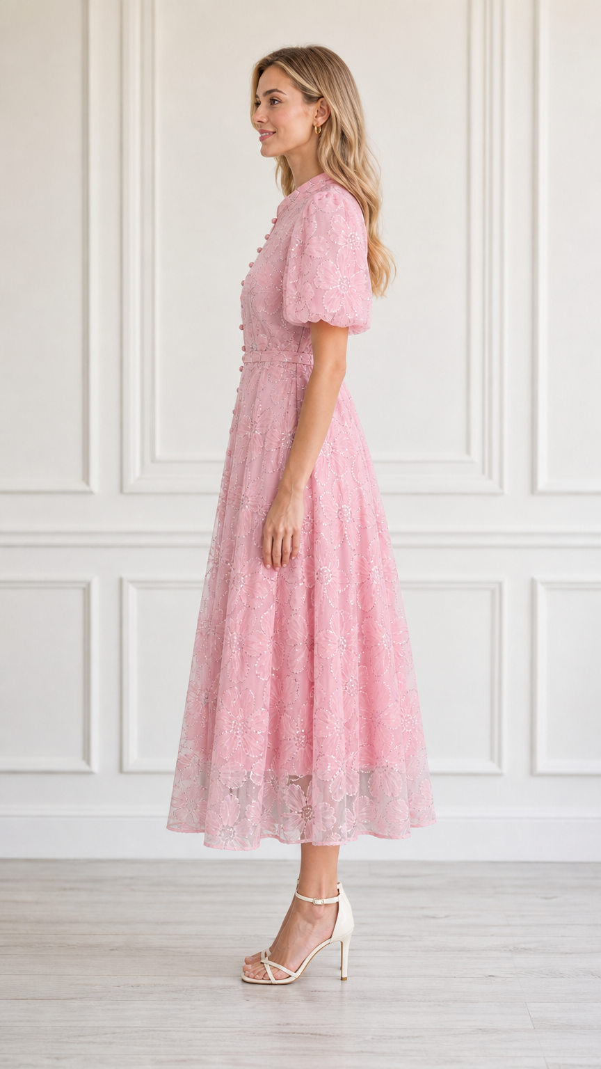 Side profile view of model in pink midi dress