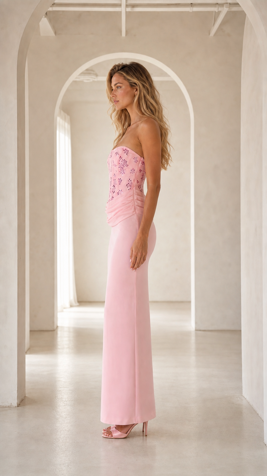 Side profile view of pink strapless corset formal maxi dress