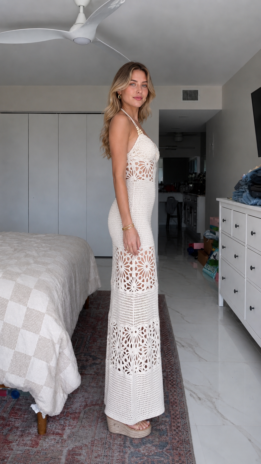 Side profile view of woman in white crochet maxi dress with wedge shoes