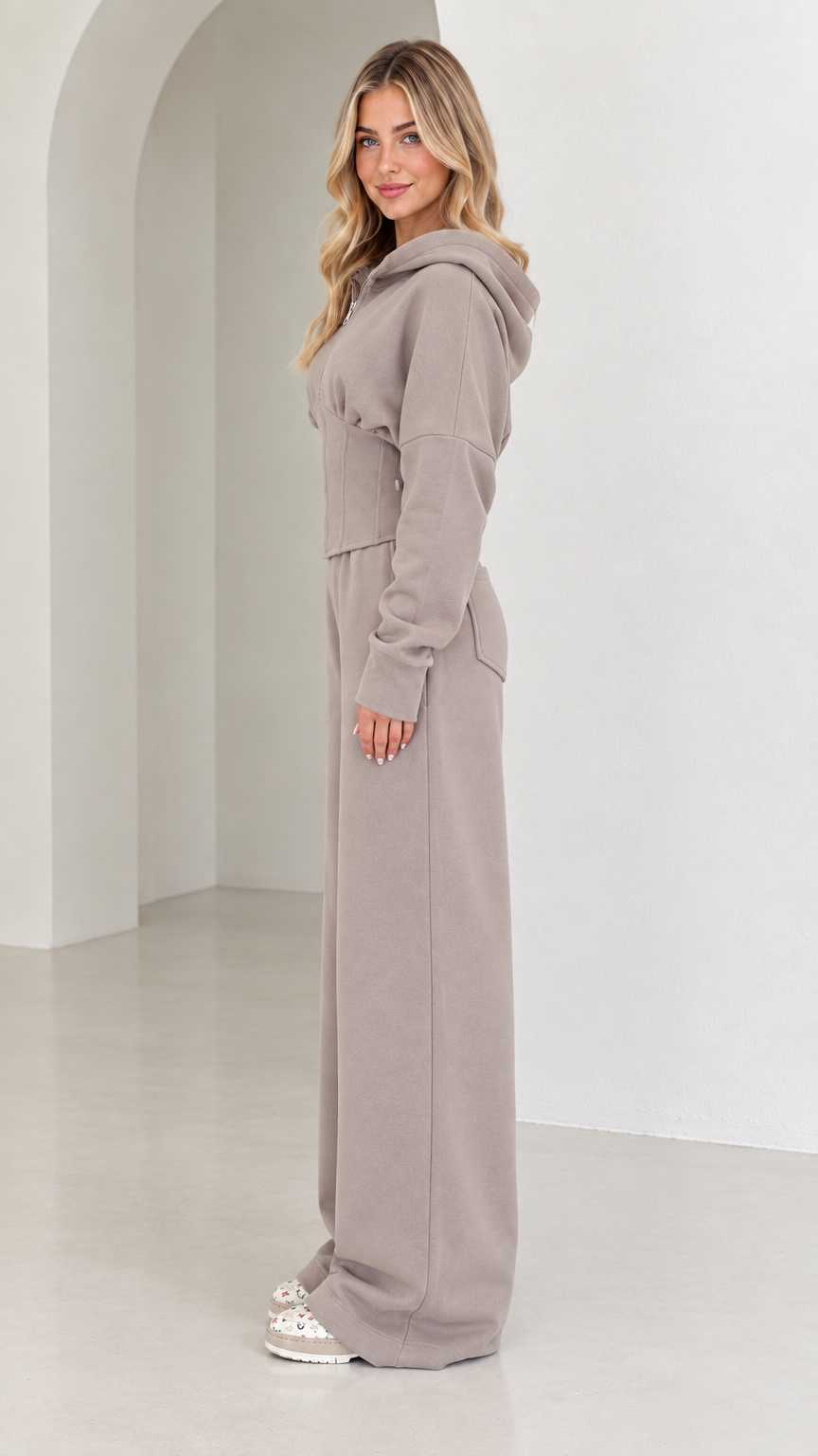 Side profile view of taupe corset tracksuit set showcasing tailored silhouette