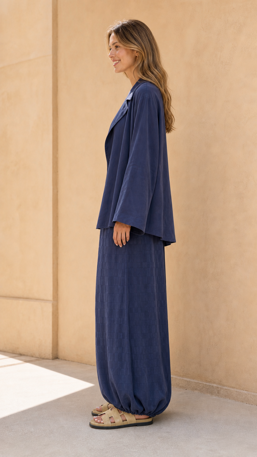 Side profile view of model in navy matching set