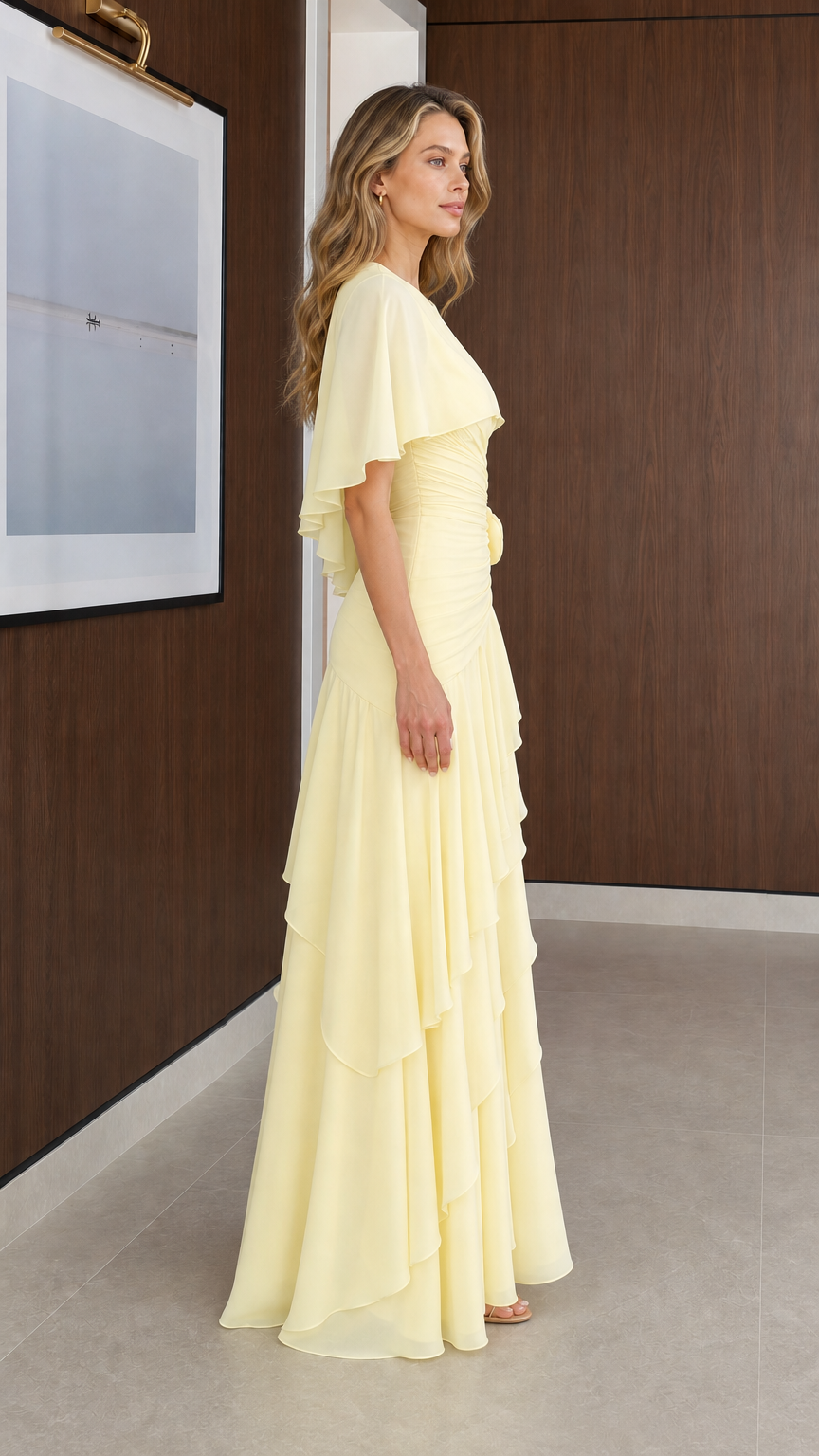 Side profile of model wearing Pale Yellow tiered capelet evening gown