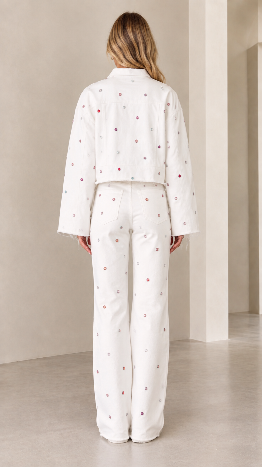Back view of woman wearing white embellished cropped jacket and wide-leg trousers