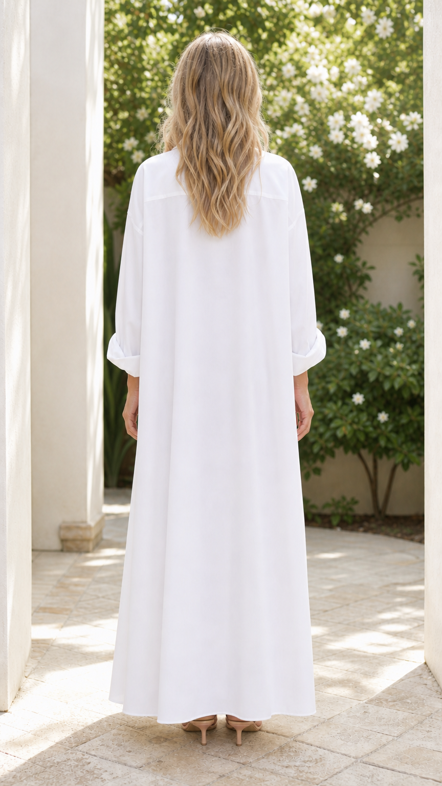 Back view of woman wearing white button down maxi shirt dress