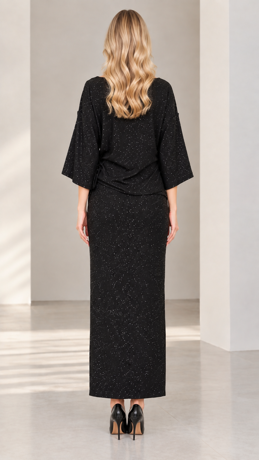 Back view of woman wearing elegant black shimmer long skirt and blouse set