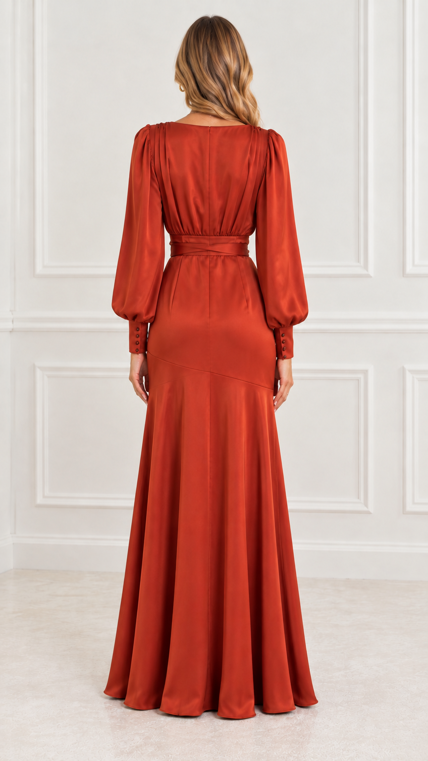 Back view of model in rust orange satin long sleeve maxi gown