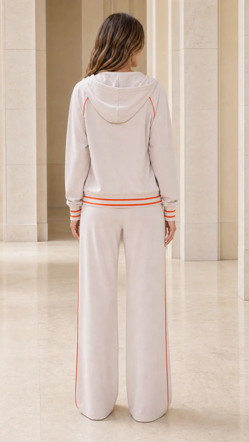 Back view of model wearing beige hooded sweatshirt and wide-leg lounge pants