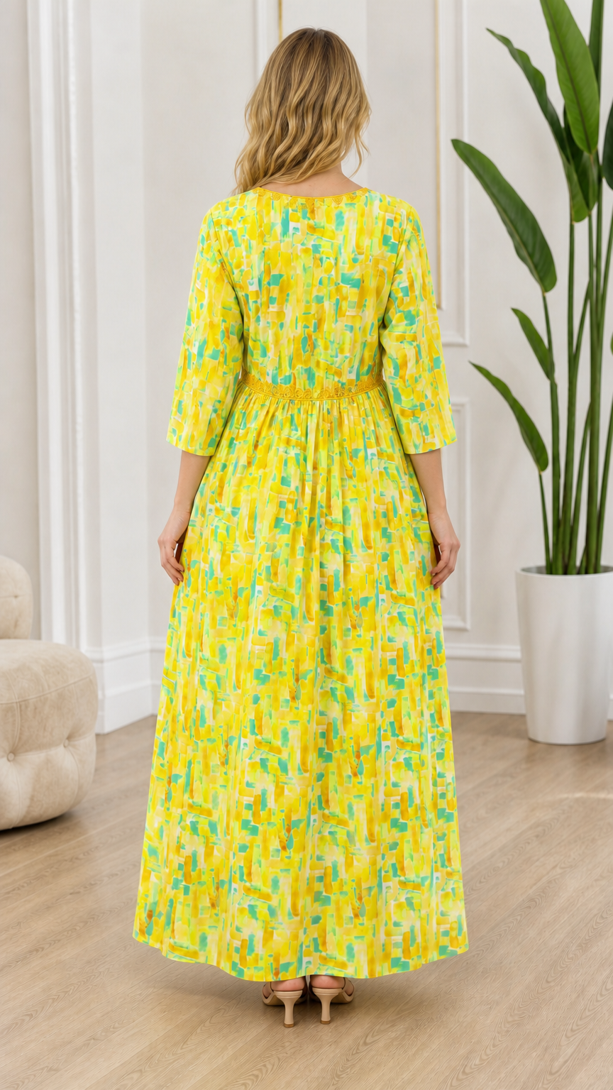 Back view of model wearing yellow patterned maxi dress with gathered empire waist