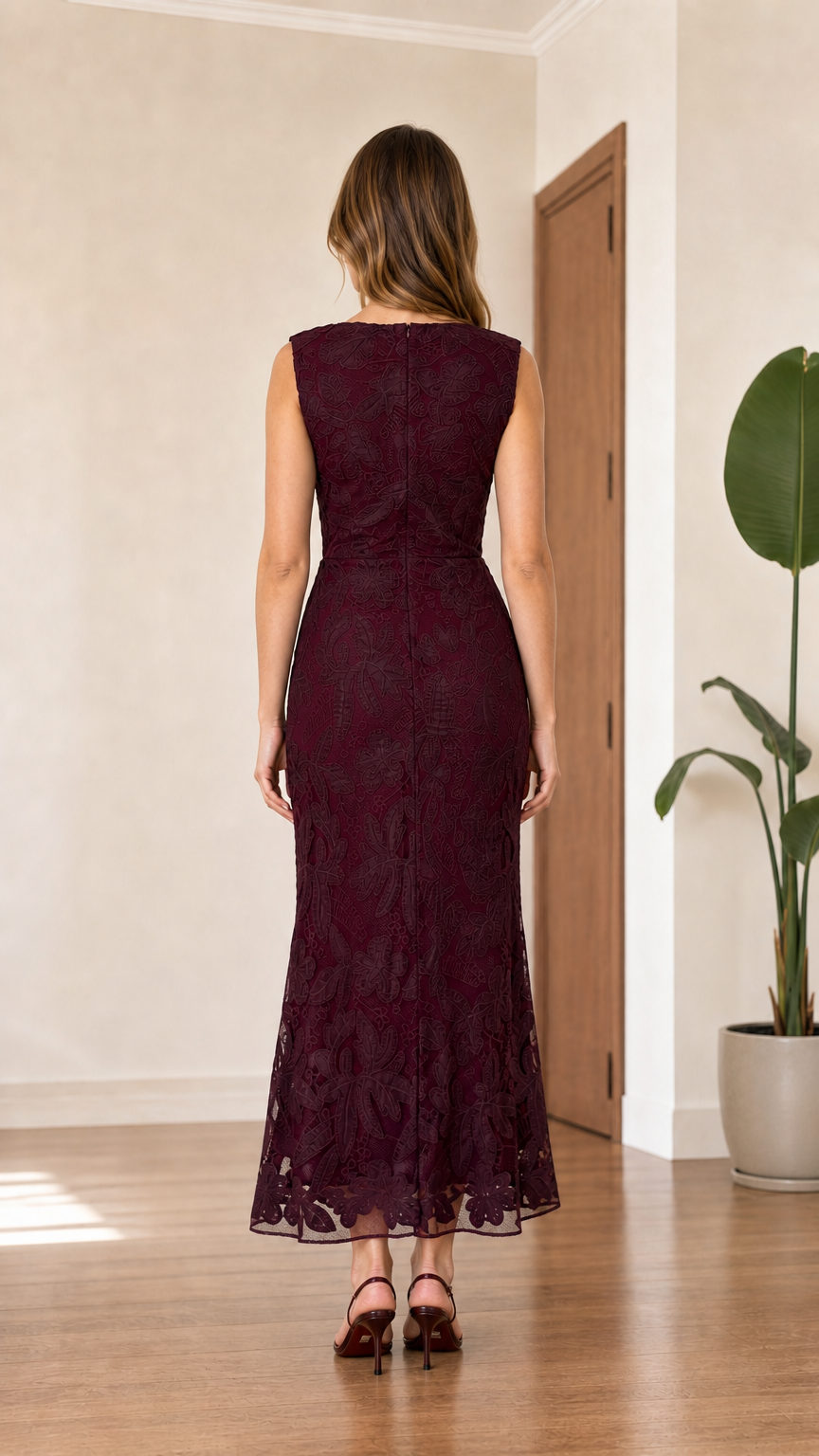 Back view of model wearing burgundy sleeveless floral lace evening dress