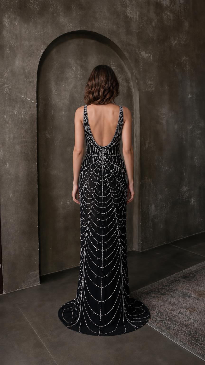 Back view of black beaded evening gown showing scoop back