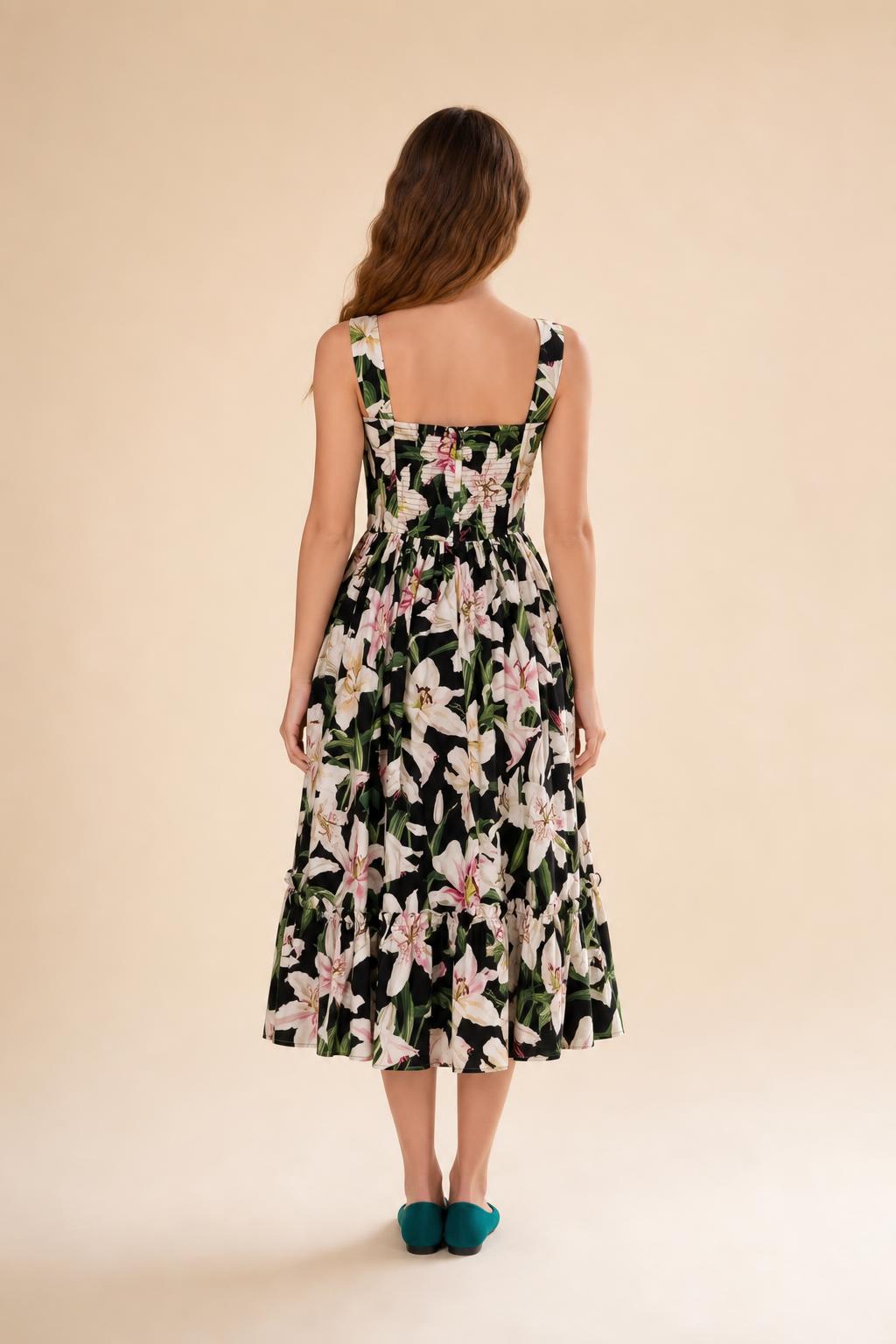 Back view of black floral midi dress against neutral background