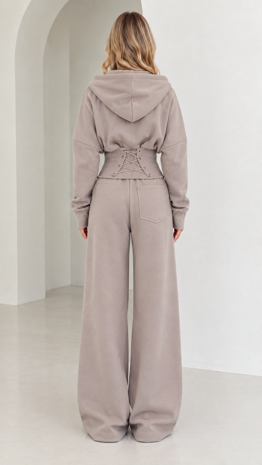 Back view of taupe set highlighting corset lace-up waist detail and wide-leg fit