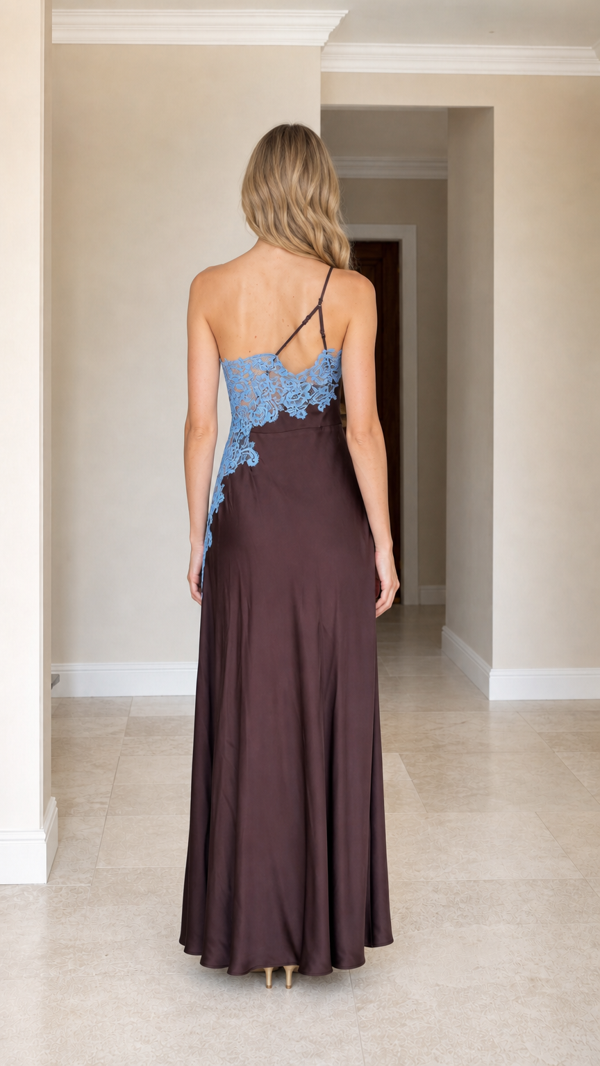 Back view of woman wearing brown one-shoulder satin maxi dress showing strap details
