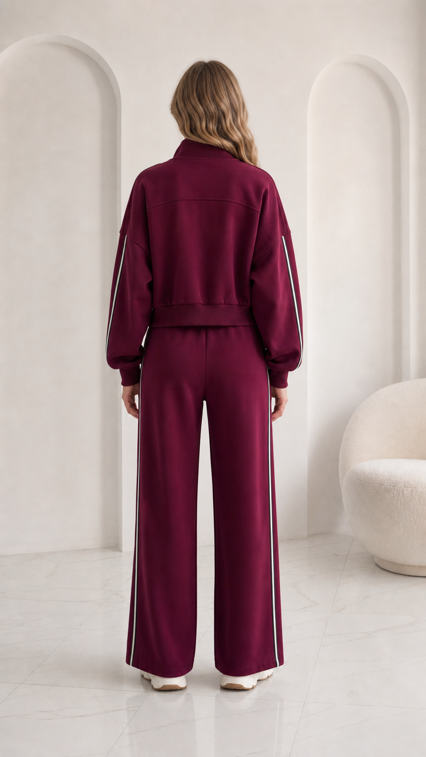 Back view of woman wearing burgundy full-zip jacket and track pants set