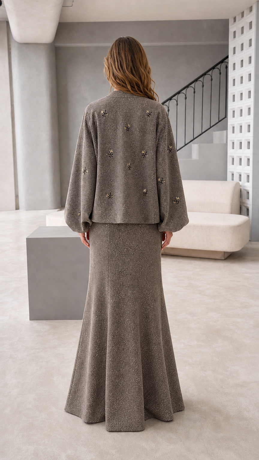 Back view of women's taupe long sleeve jacket and maxi skirt set
