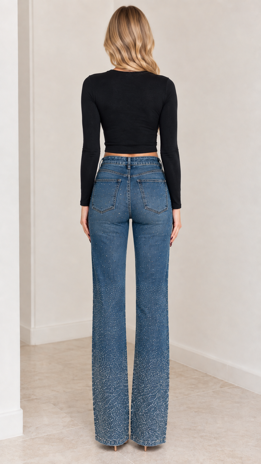 Back view of model in rhinestone-embellished high-rise flare jeans