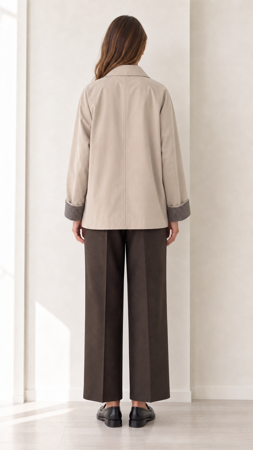Back view of women's beige short trench jacket showing clean tailoring
