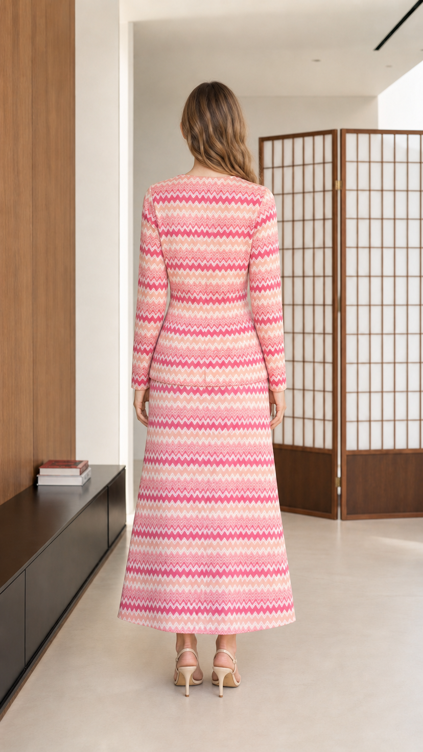 Back view of model wearing pink chevron knit long sleeve top and maxi skirt