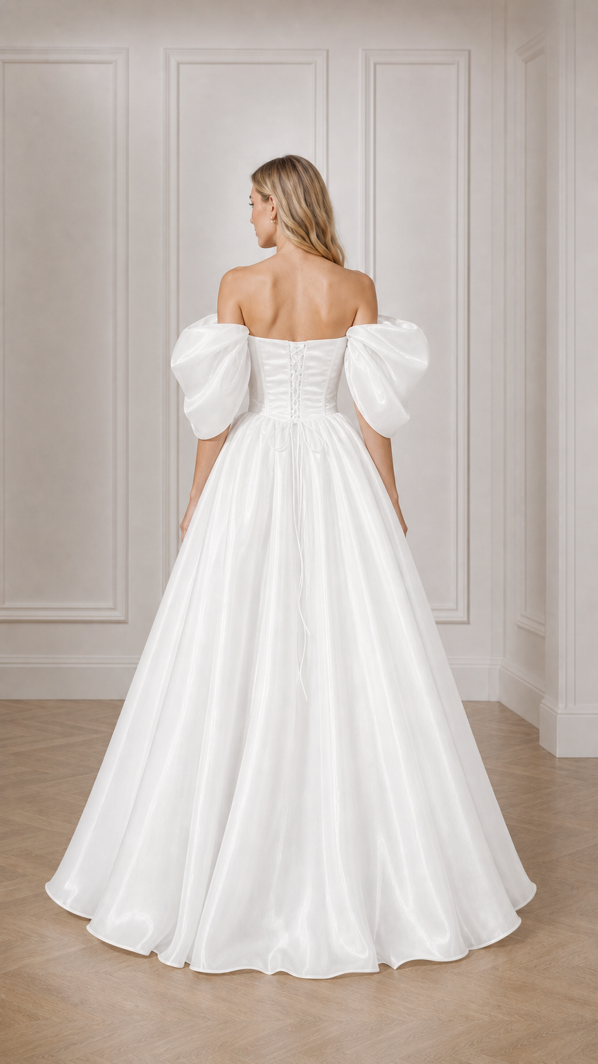 Back view of woman showing lace-up back detail of white ball gown