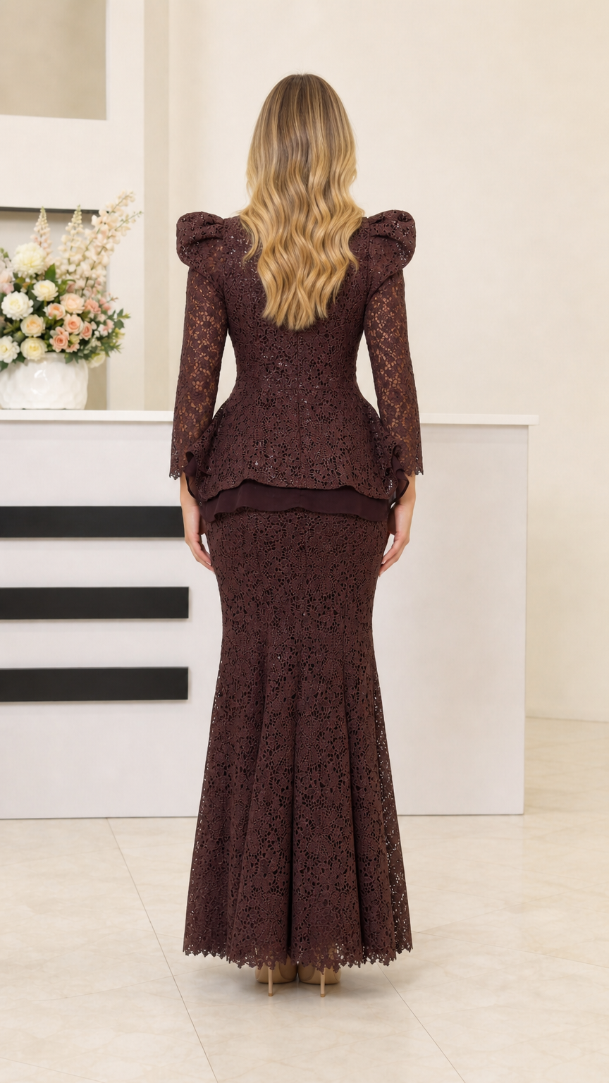 Back view of dark brown lace evening dress with peplum detail
