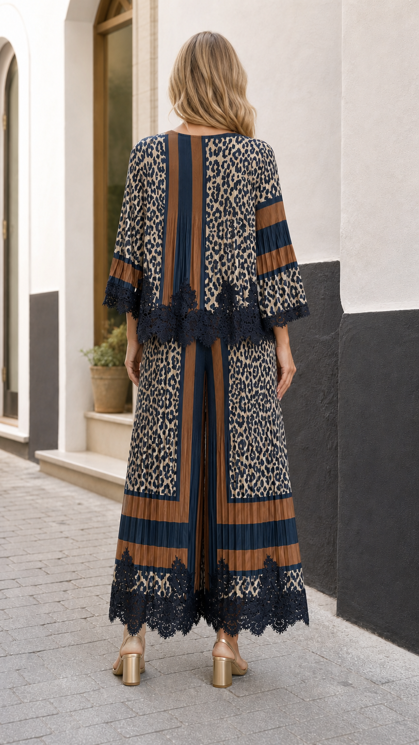 Back view of model wearing the pleated animal print top and wide-leg trousers