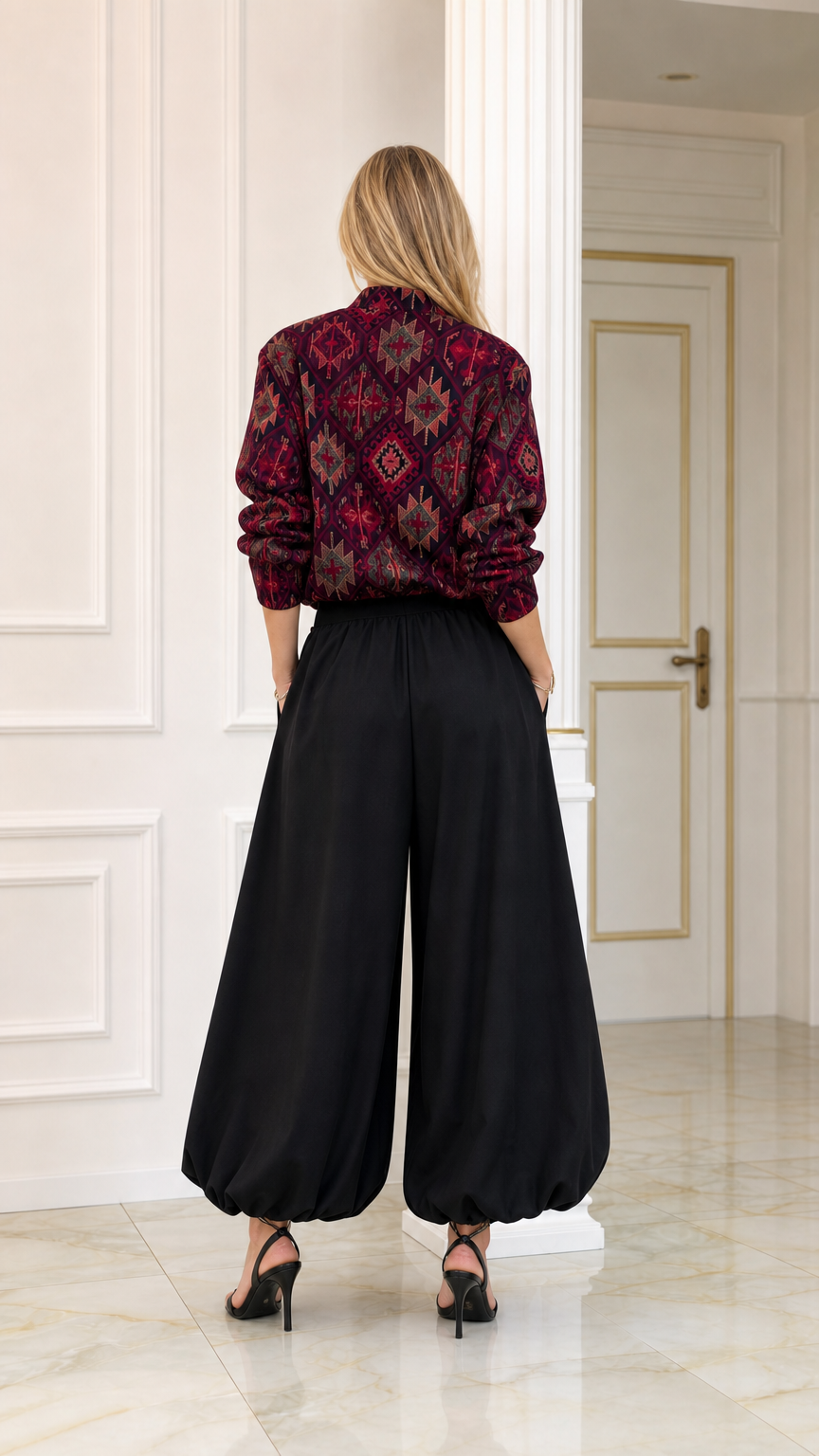Back view of burgundy ethnic pattern long-sleeve blouse and black wide balloon trousers