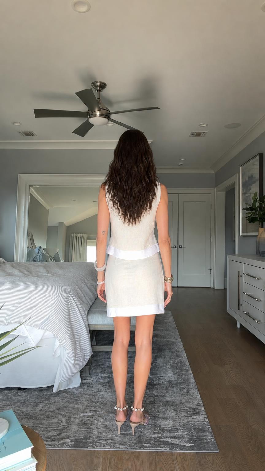 Back view of model in beige two-piece outfit