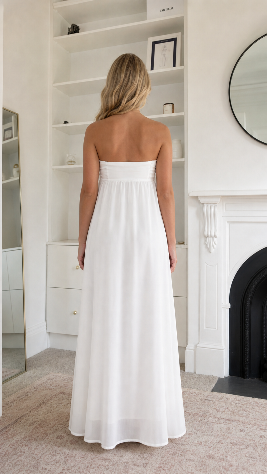 Back view of woman wearing white strapless maxi dress