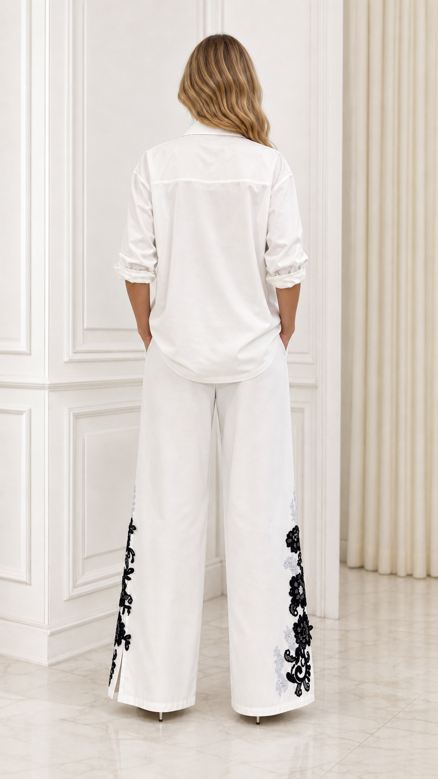 Back view of white embroidered shirt and wide-leg trousers